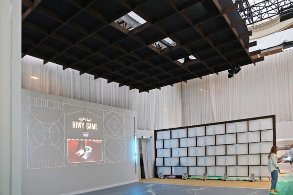 Play room with projections on wall and floor, timber grid ceiling panel above