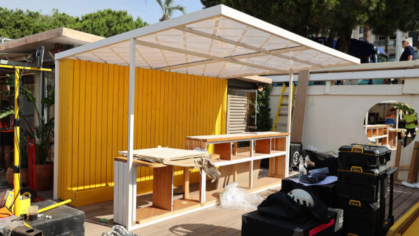 Image of yellow back wall and overhead canopy welcome area