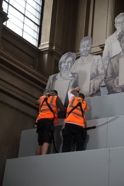 Large scale portrait being installed into display structure