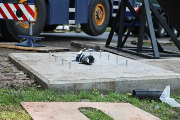 A concrete base with protruding steel bolts