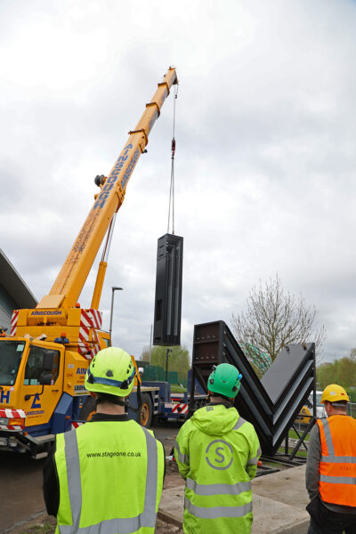 A steel structure being lifted by crane