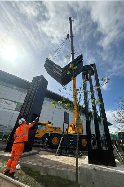 A steel structure being lifted by crane