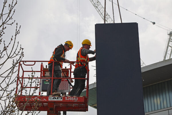 Stage One team elevated in a cherry picker to secure the fitting of a steel structure