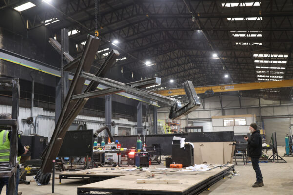 Image of steel structure being lifted in metal workshop