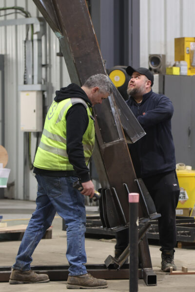 Stage One team guiding the lifting of a metal structure