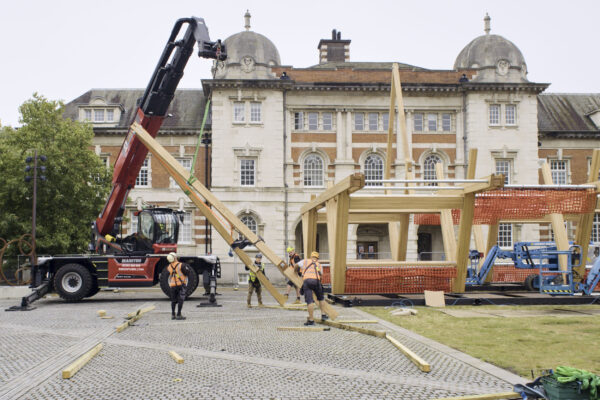 Stage One team constructing timber structure with net seating in front of Chelsea College of Arts, London