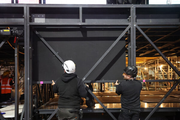 Image of Stage One team installing cladding to stage