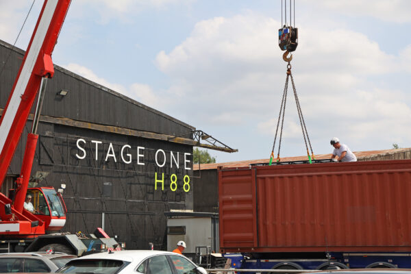 Image of crane loading materials into a container