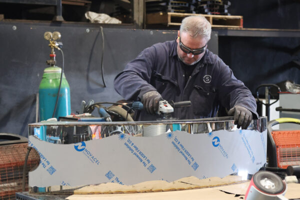 Image of worker processing metal cladding